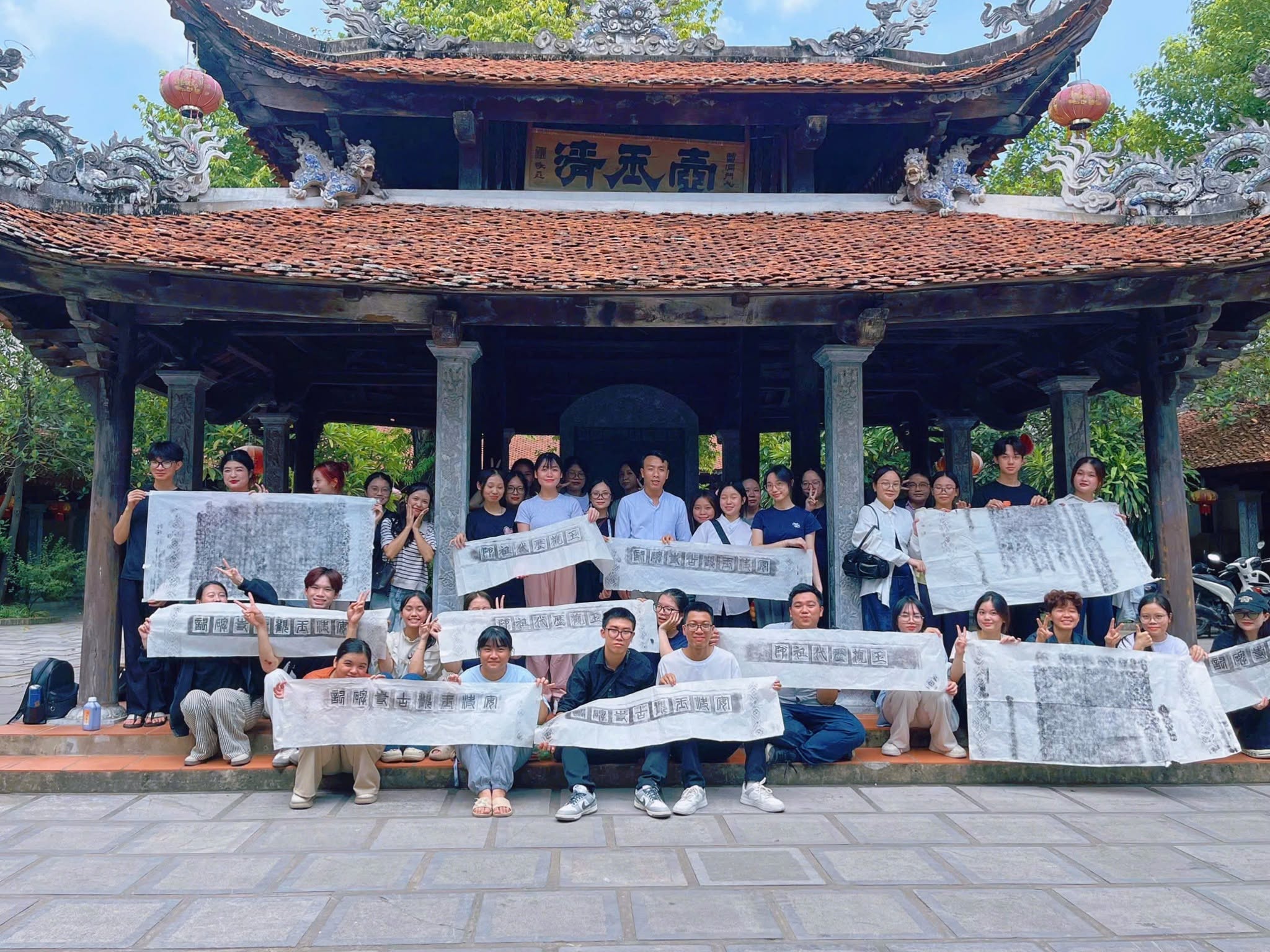A group of people holding signs
Description automatically generated